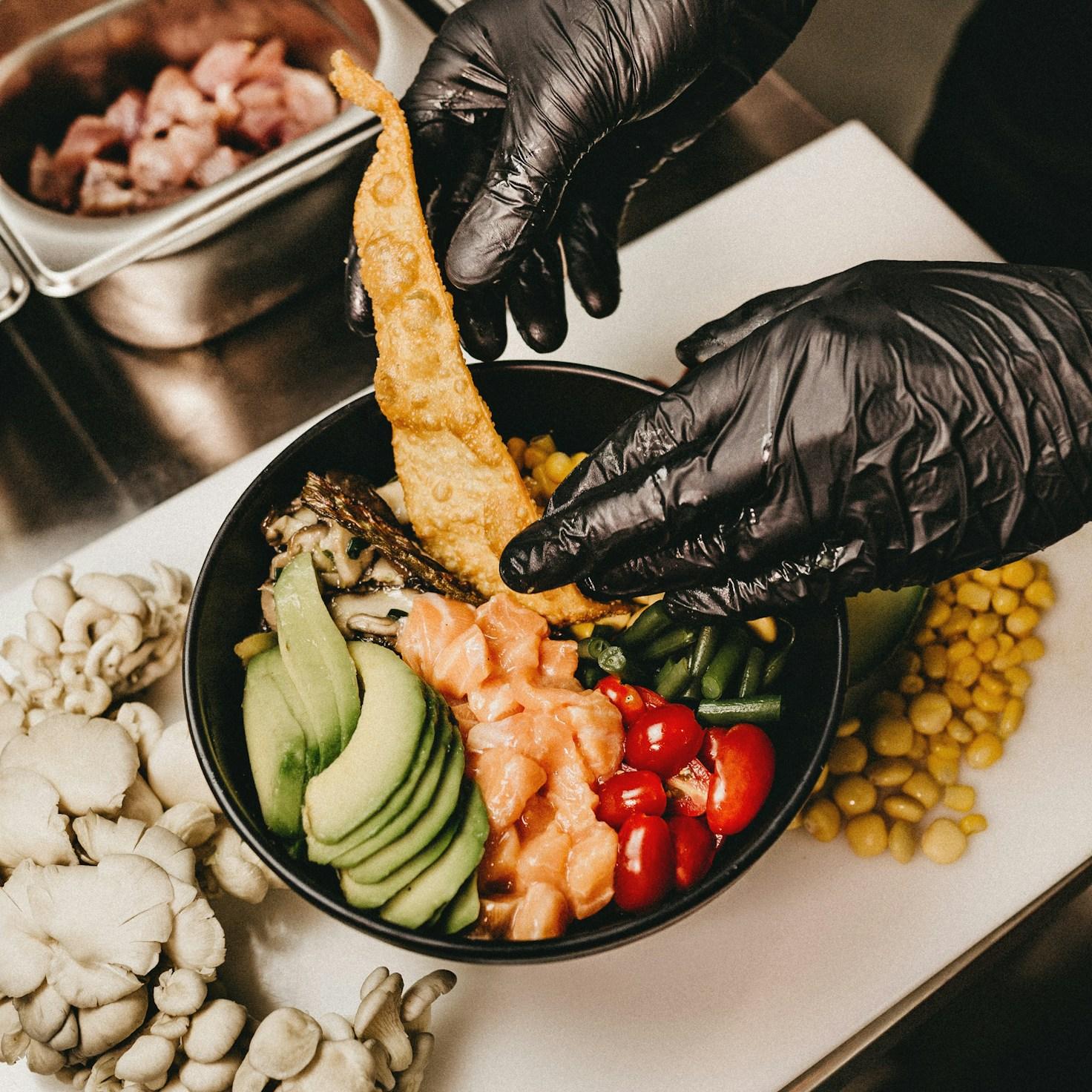 Community members collaborating in a contemporary kitchen, exchanging recipes and techniques